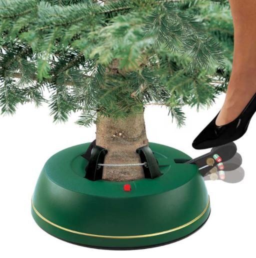 Green Christmas tree stand with a foot pedal being pressed.