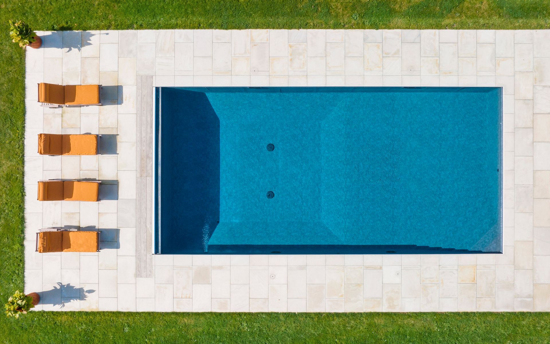 Drone view onto a luxury swimming pool.