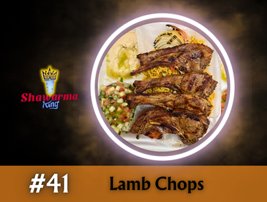 Lamb chops on a plate, beside hummus, salad, and rice, from Shawarma King.