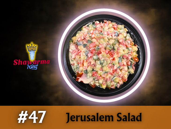 Jerusalem salad in a black bowl, with a glowing ring, and the 