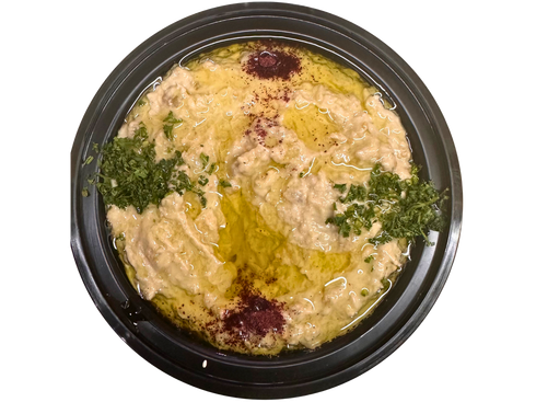 Baba Ghanoush in a black bowl, drizzled with olive oil and garnished with parsley and paprika.