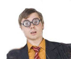 A man in a suit and tie is wearing glasses and a tie.