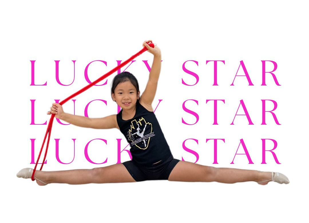 Girl in a split, stretching with a red ribbon.