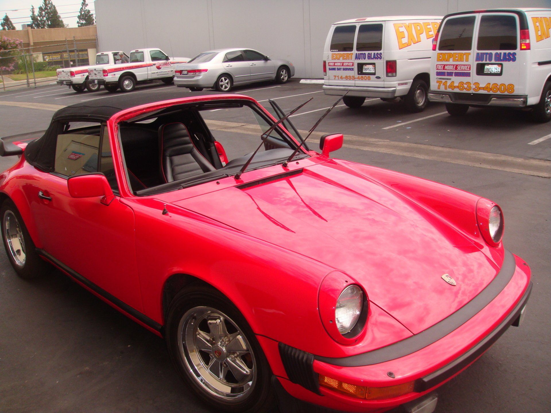 Replacing Glass on the Red Car — Orange County, CA — Expert Auto Glass Tiny & Upholstery