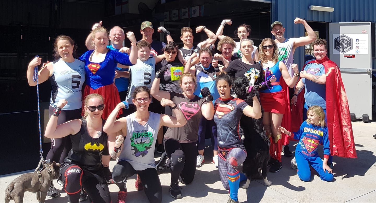 A group of people dressed as superheroes are posing for a picture at Marky Marks Personal Training & Gym in Moss Vale