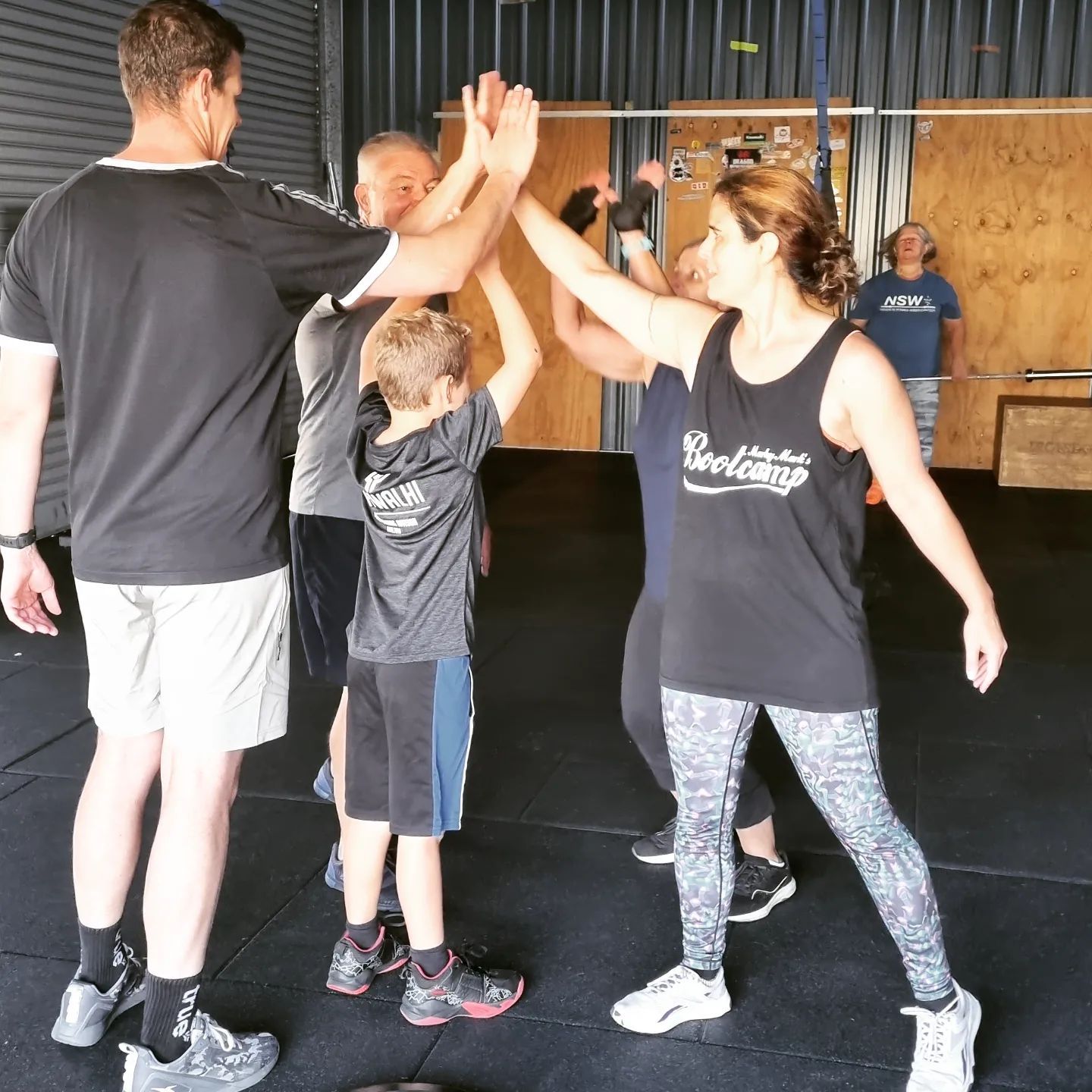 A group of people giving each other a high five at Marky Marks Personal Training & Gym in Moss Vale
