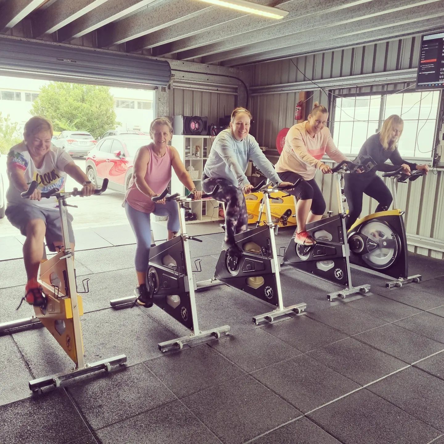 A group of people are riding exercise bikes at Marky Marks Personal Training & Gym in Moss Vale