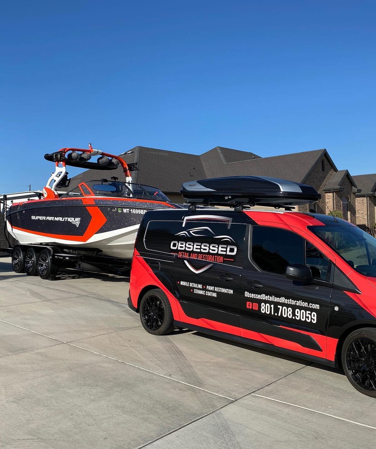 A person is using a blue squeegee to remove plastic from the hood of a car