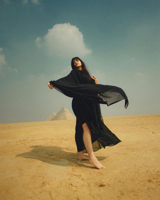 Woman posing in the Egyptian desert near the pyramids