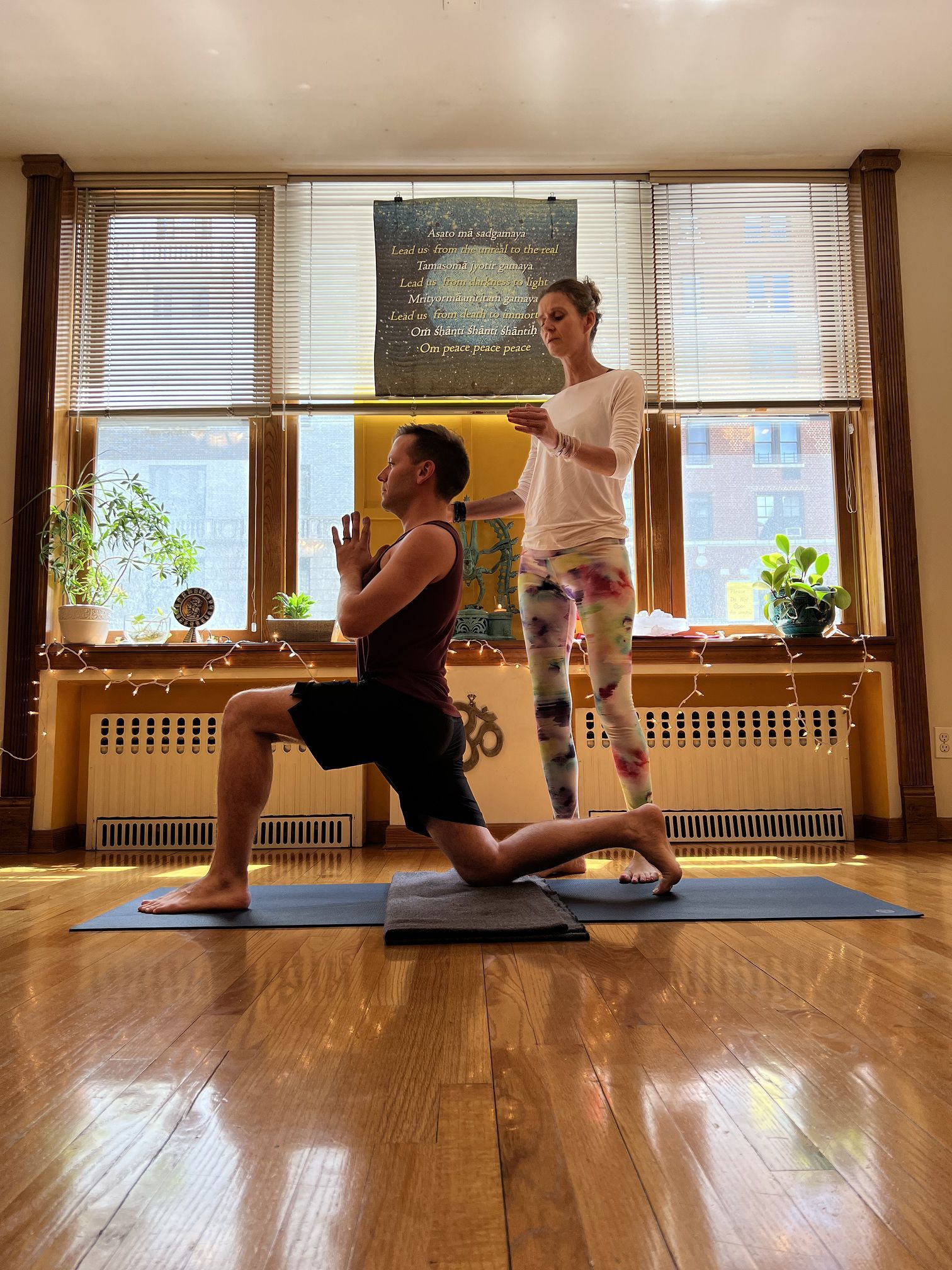 Woman with curly brown hair smiles at camera.