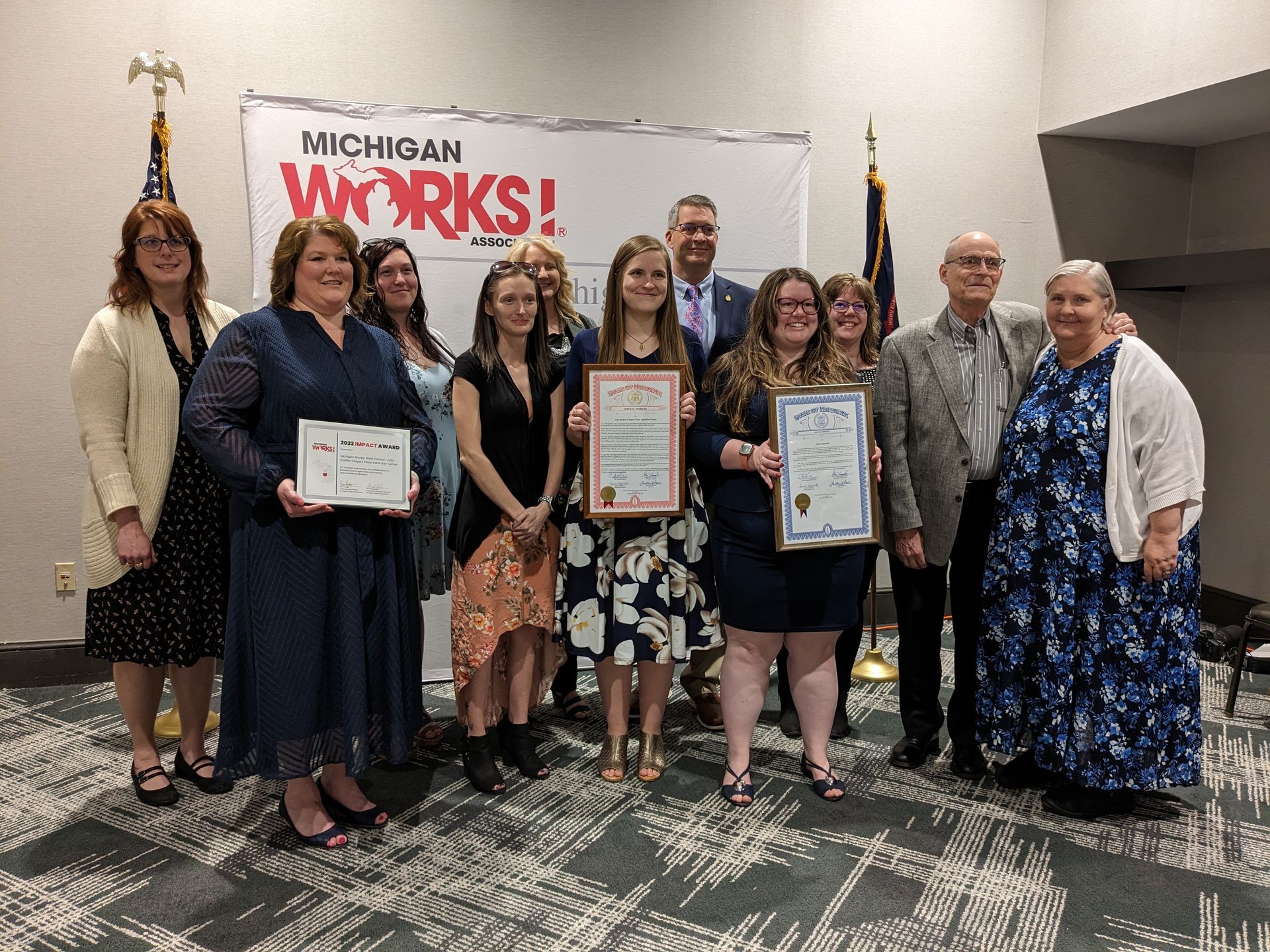 Julia Sheffer (center) recently received a 2023 Impact Award from Michigan Works! West Central for earning her CNA training. She is pictured with members of the Michigan Works! West Central staff, coworkers, her parents and more.