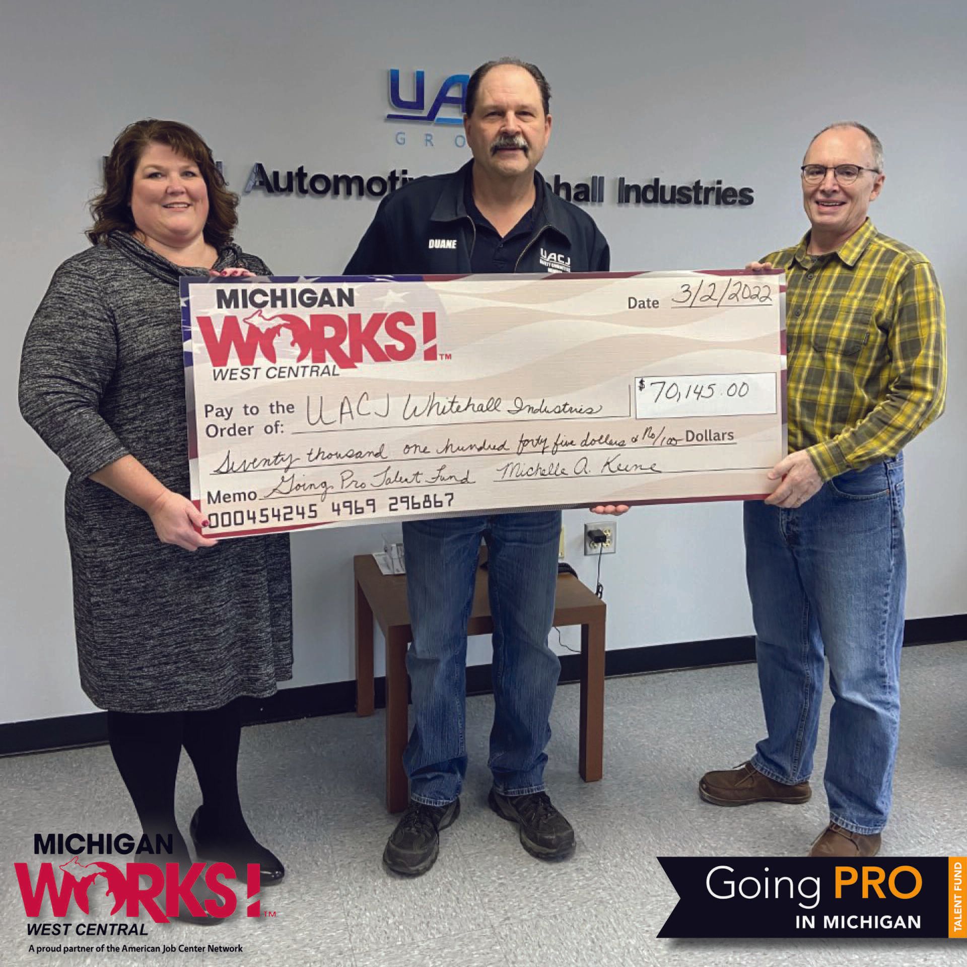 Michigan Works! West Central Executive Director Shelly Keene presents a reimbursement check to UACJ Whitehall Industries staff members for completing their Going PRO Talent Fund training plan.