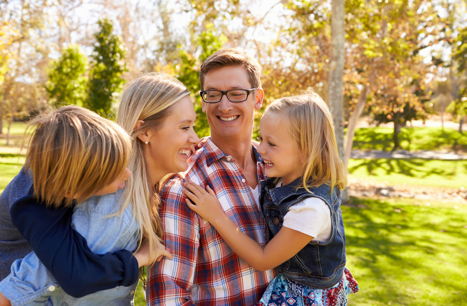 A group of people are hugging each other in a room.