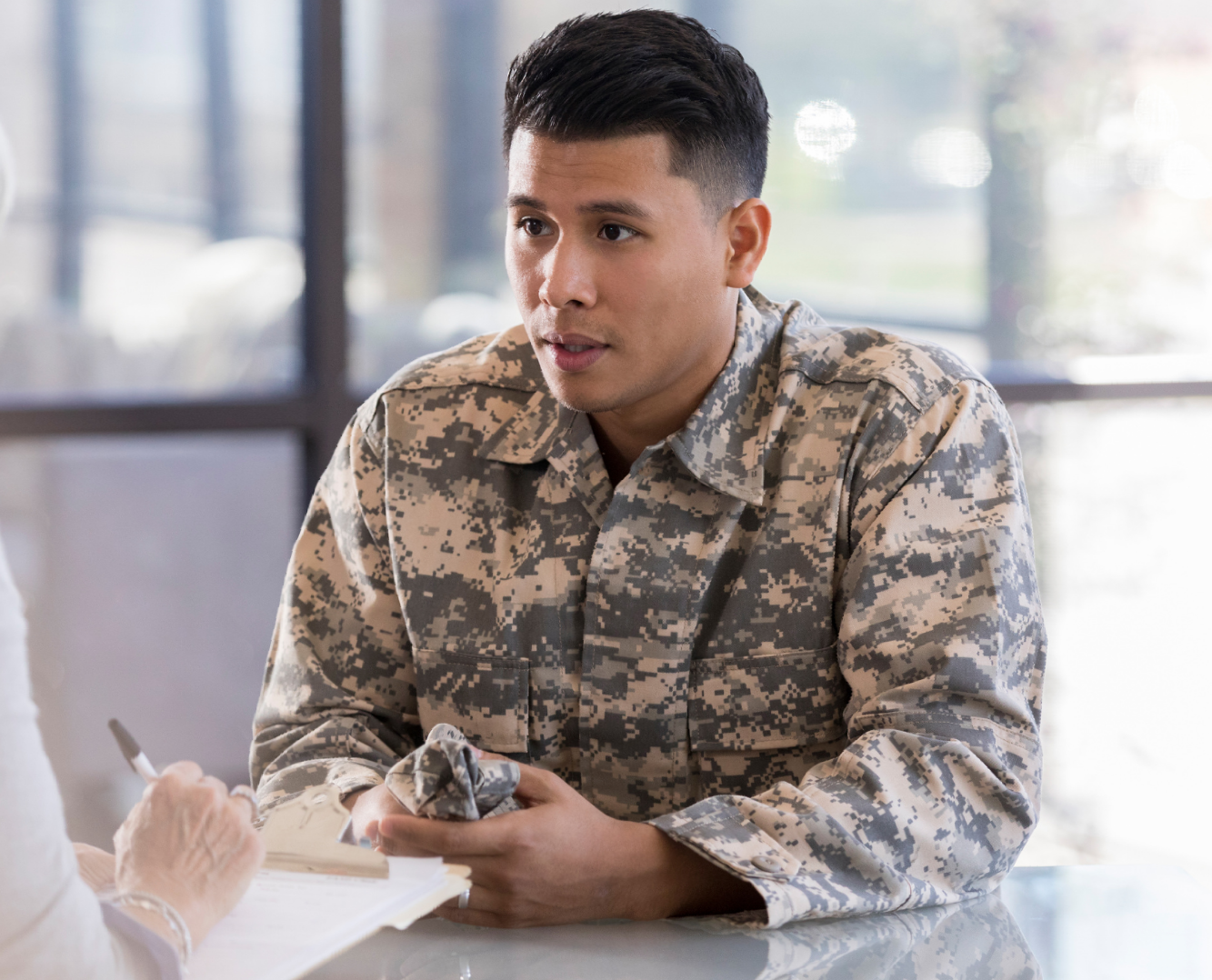 A group of people are sitting in a circle talking to each other.