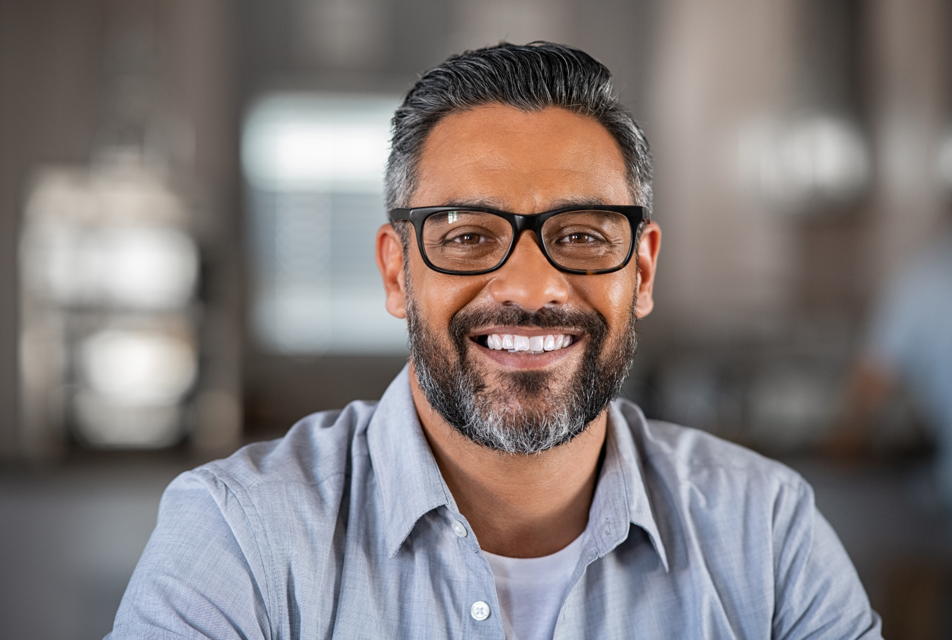 A woman is sitting at a table talking to a doctor.