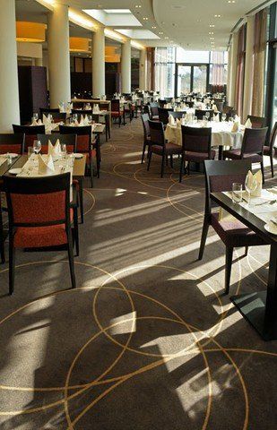 Ein großes Esszimmer mit Tischen und Stühlen für eine Mahlzeit.