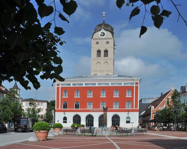 Ein rot-weißes Gebäude mit einem Uhrenturm auf der Spitze