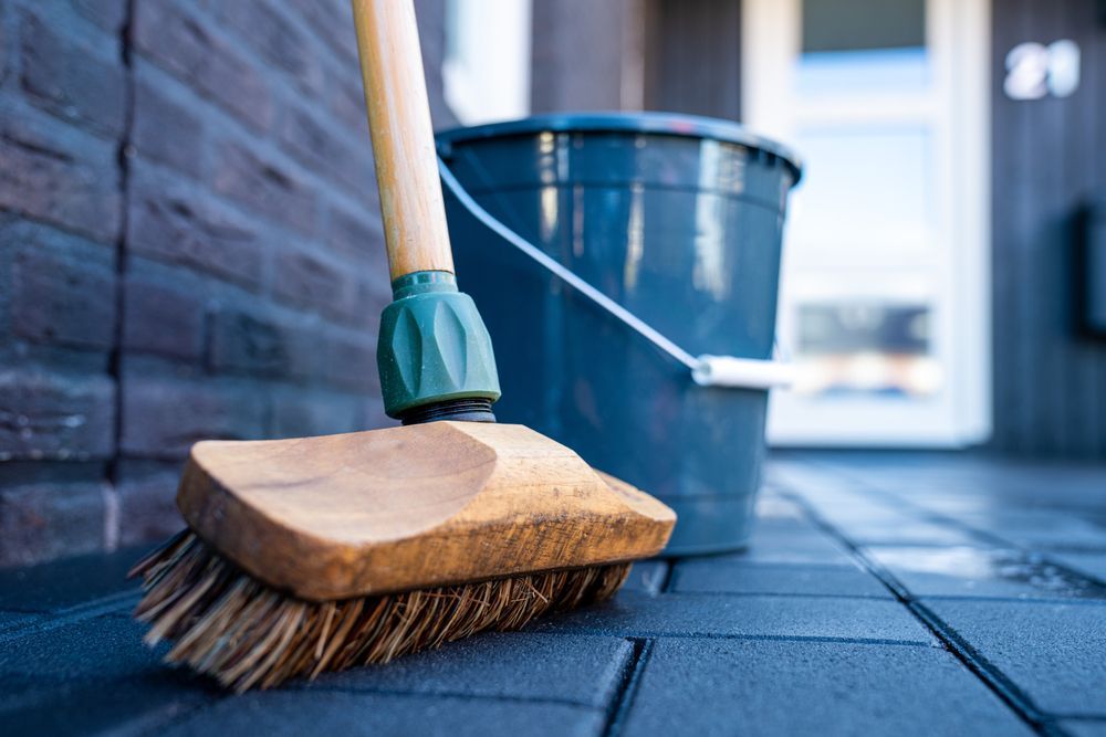 Tools used to clean a concrete driveway.