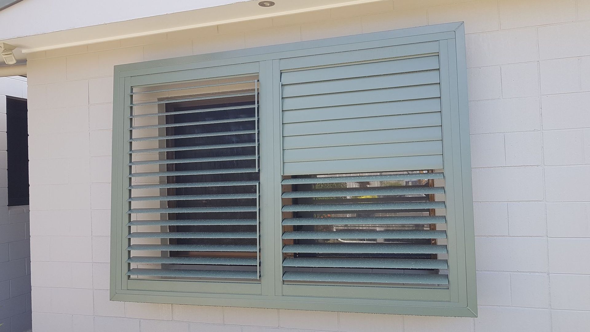A Room with Sliding Glass Doors and White Louvres on The Windows — A & B Lattice World & Patios in Bungalow, QLD