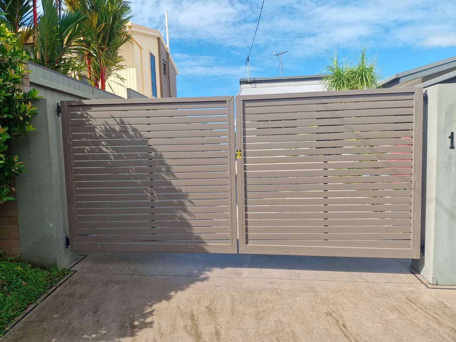 A Fence Is Sitting in Front of A House with A Sliding Glass Door  — A & B Lattice World & Patios in Bungalow, QLD
