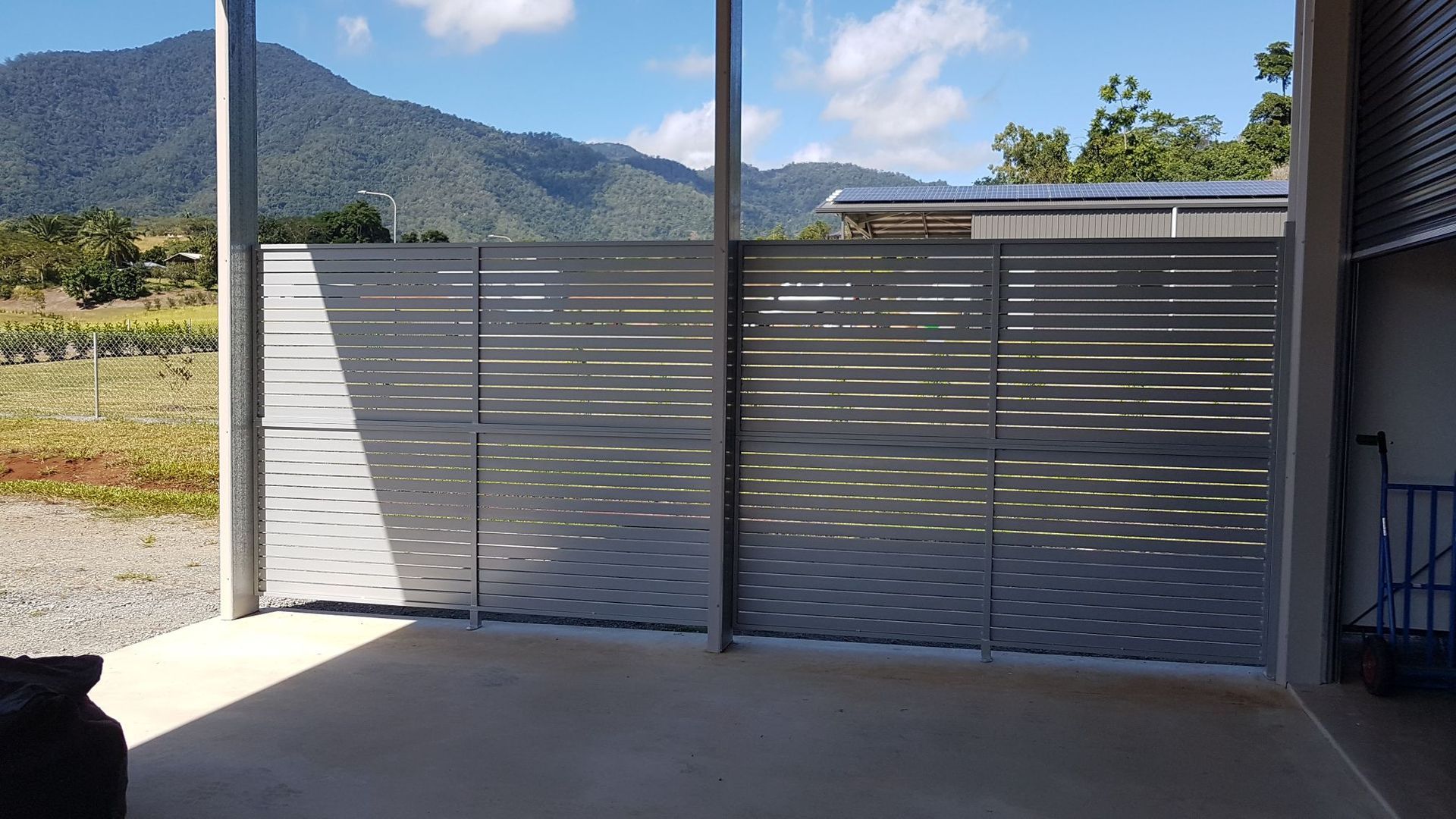 A Building with A Fence in Front of It and A Sliding Glass Door  — A & B Lattice World & Patios in Bungalow, QLD