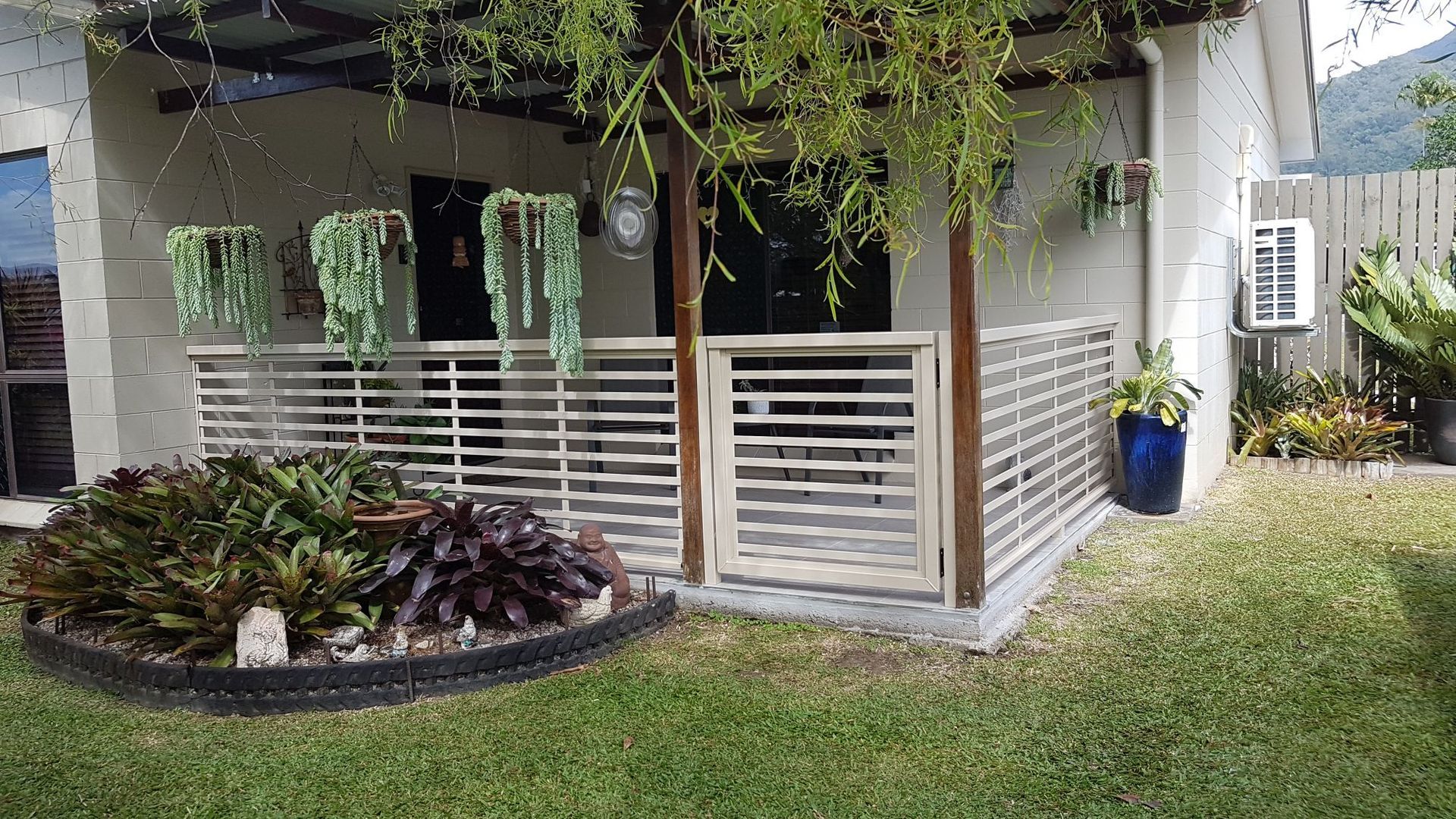 A Brick House with A Wooden Lattice on The Side of It  — A & B Lattice World & Patios in Bungalow, QLD