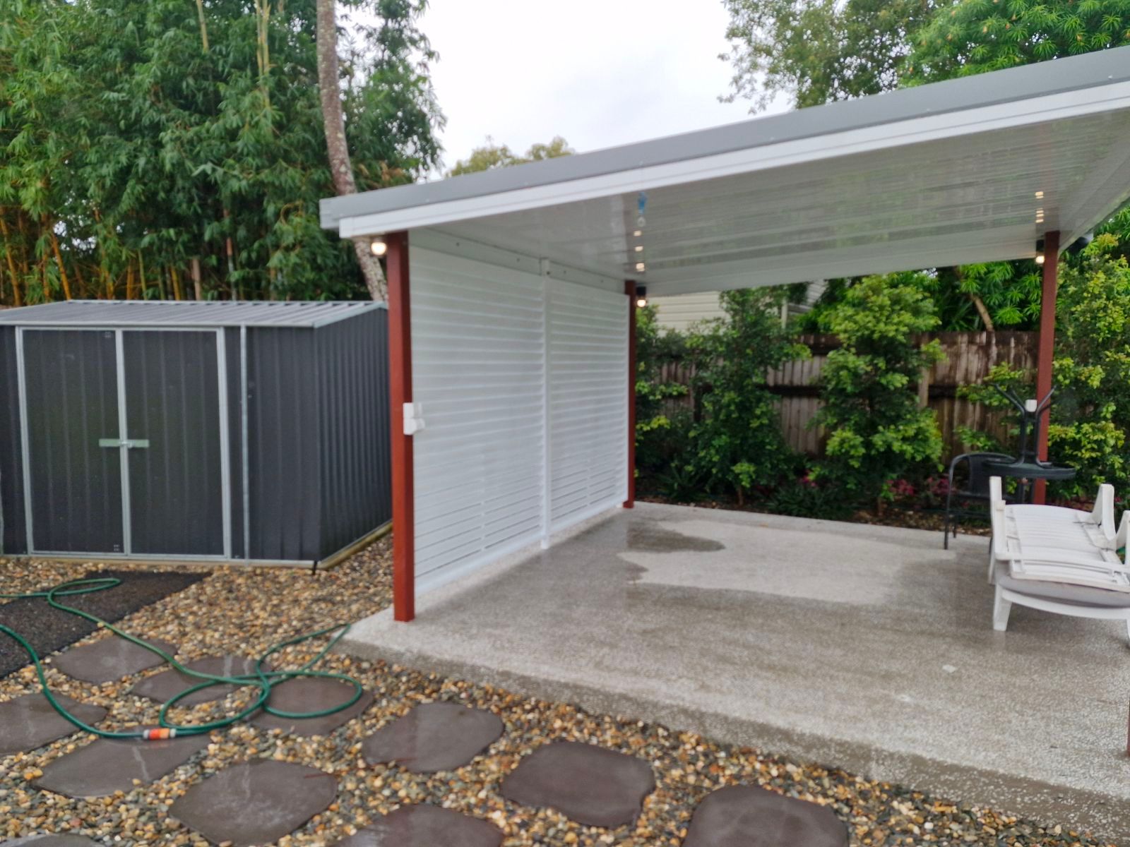 A White Lattice Box Is Sitting in Front of A Brick Building  — A & B Lattice World & Patios in Bungalow, QLD