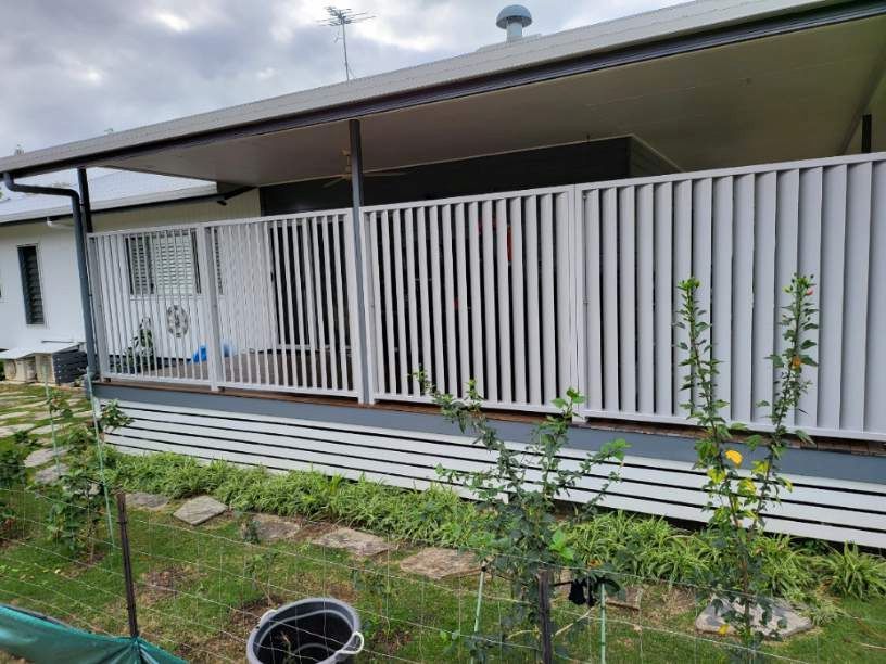 A White Fence Surrounds a Porch of a House — A & B Lattice World & Patios In Tablelands, QLD