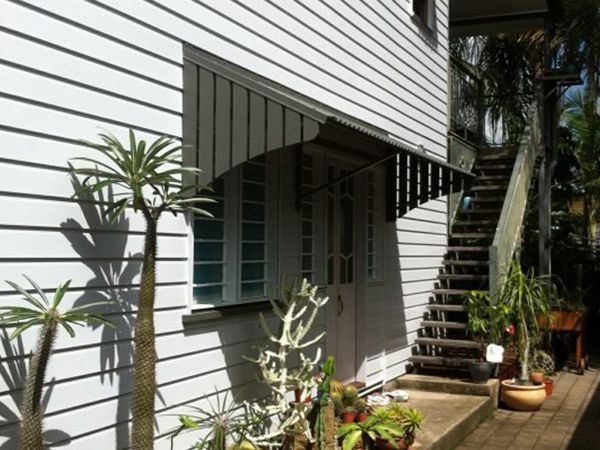 A White House with Stairs Leading up To the Second Floor — A & B Lattice World & Patios in Bungalow, QLD