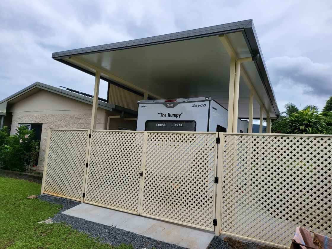 A White Gate and A Door Are Sitting Next to Each Other on A Brick Driveway  — A & B Lattice World & Patios in Bungalow, QLD
