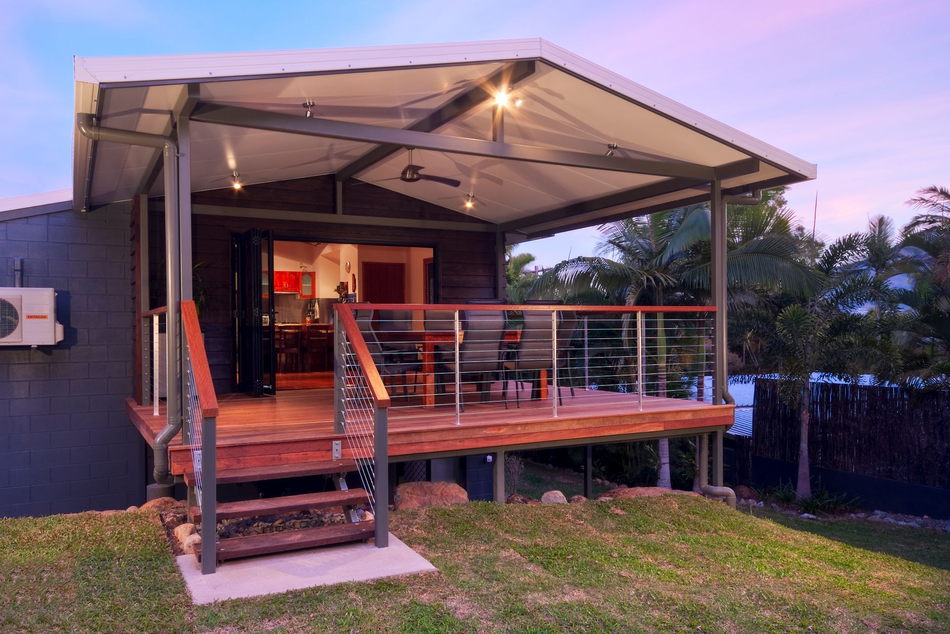 A Deck with Lighting and Stair Leading onto Grass — A & B Lattice World & Patios in Bungalow, QLD