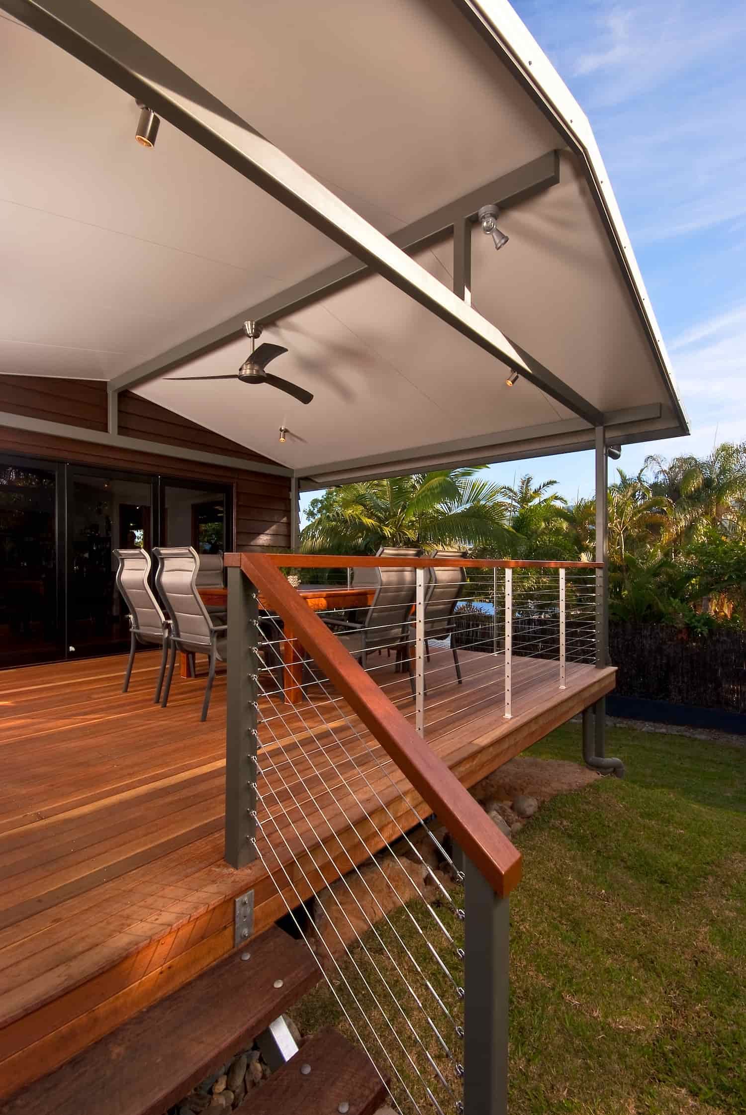 A Wooden Deck With a Ceiling Fan and Stairs — A & B Lattice World & Patios In Tablelands, QLD