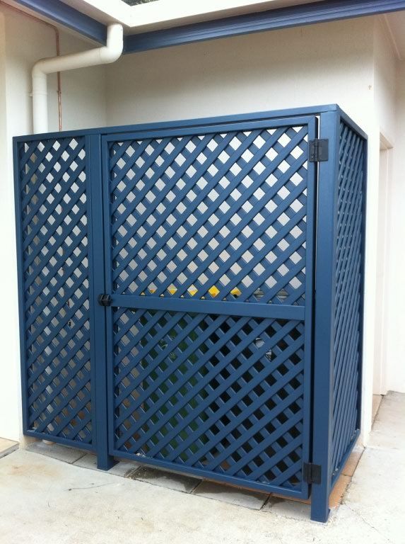 A Blue Lattice Fence with A Door on The Side of A Building — A & B Lattice World & Patios in Northern Beaches, QLD