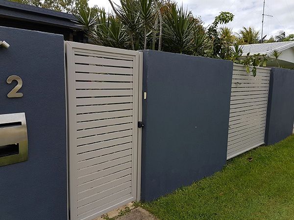 A Fence with A Gate and A Mailbox in Front of It — A & B Lattice World & Patios in Bungalow, QLD