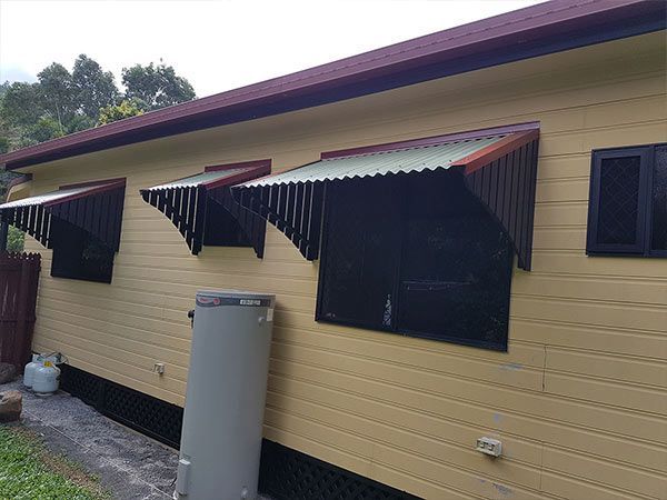 A House with A Water Heater on The Side of It — A & B Lattice World & Patios in Bungalow, QLD