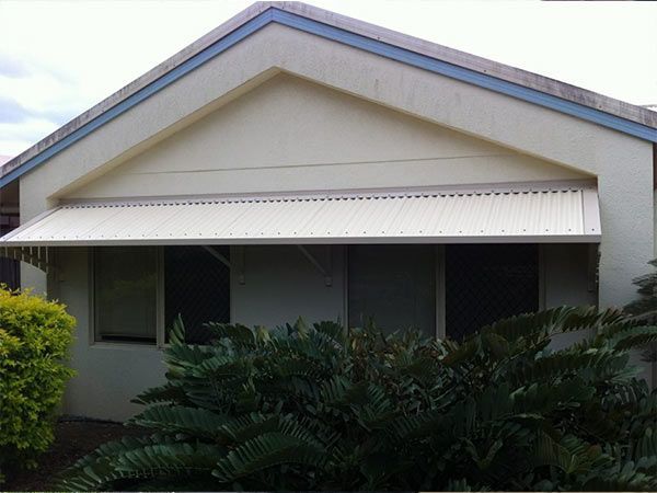 A White House with A Blue Roof and A White Awning — A & B Lattice World & Patios in Bungalow, QLD