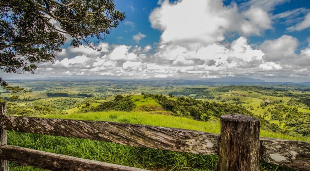 A Wooden Fence With A View Of A Lush Green Hillside — A & B Lattice World & Patios in Tablelands, QLD