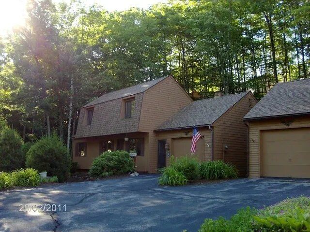 Brown House with US Flag — Laconia, NH — Rooftop Construction LLC