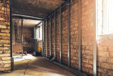 room with exposed brick walls and a window