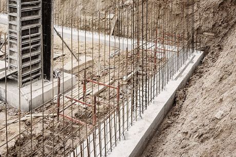 a construction site with a concrete slab and a building under construction