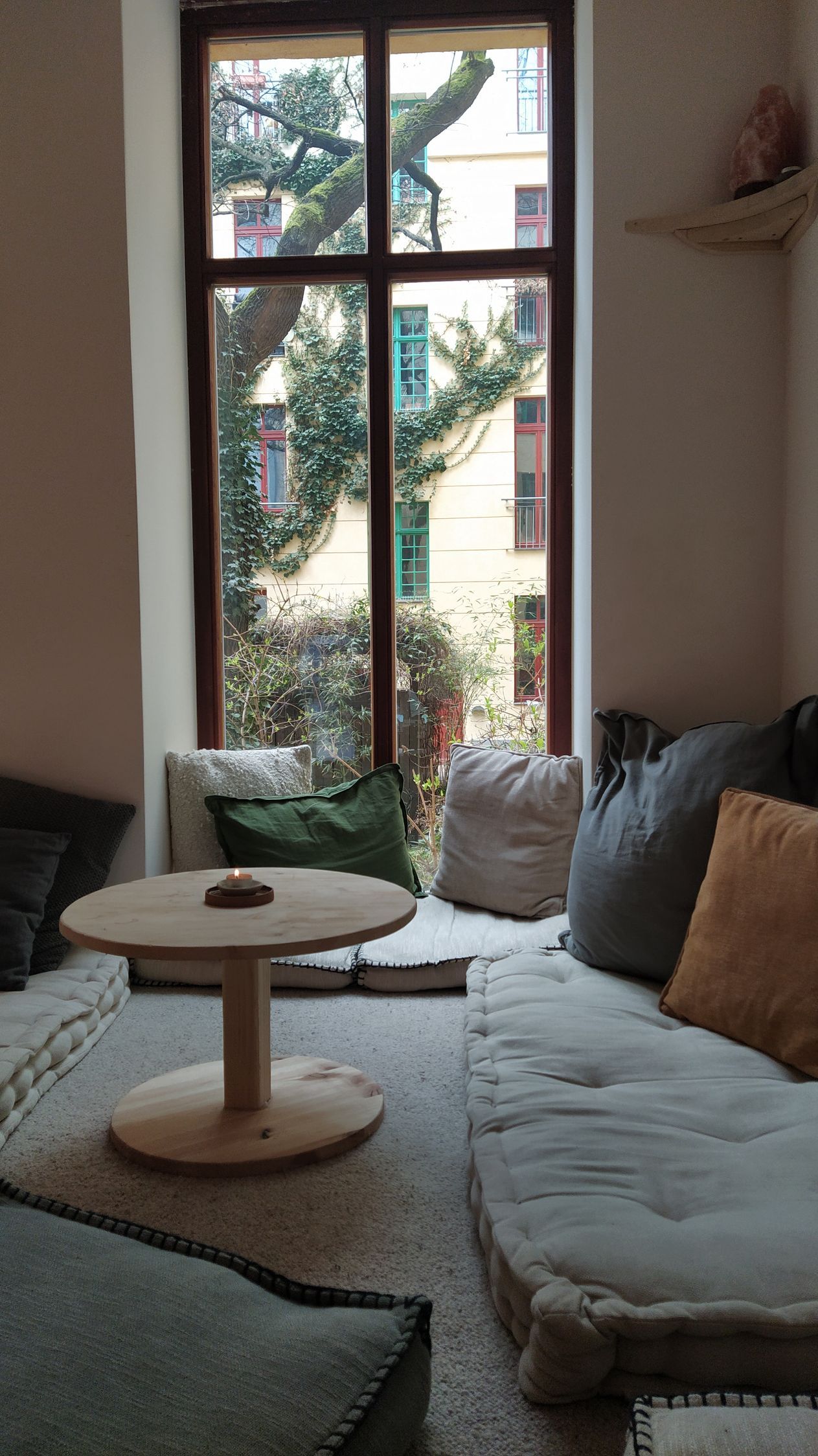 seating in Teeraum Sanvian in front of a window.