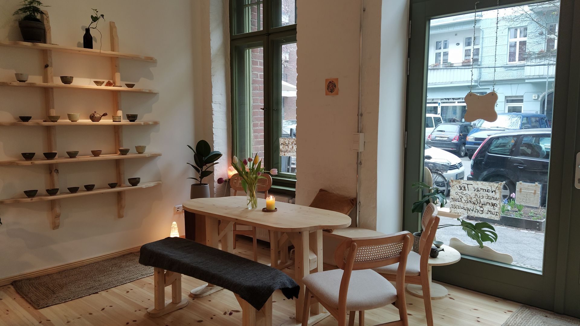 Teeraum Sanvian in Berlin with a table and chairs in front of a window.