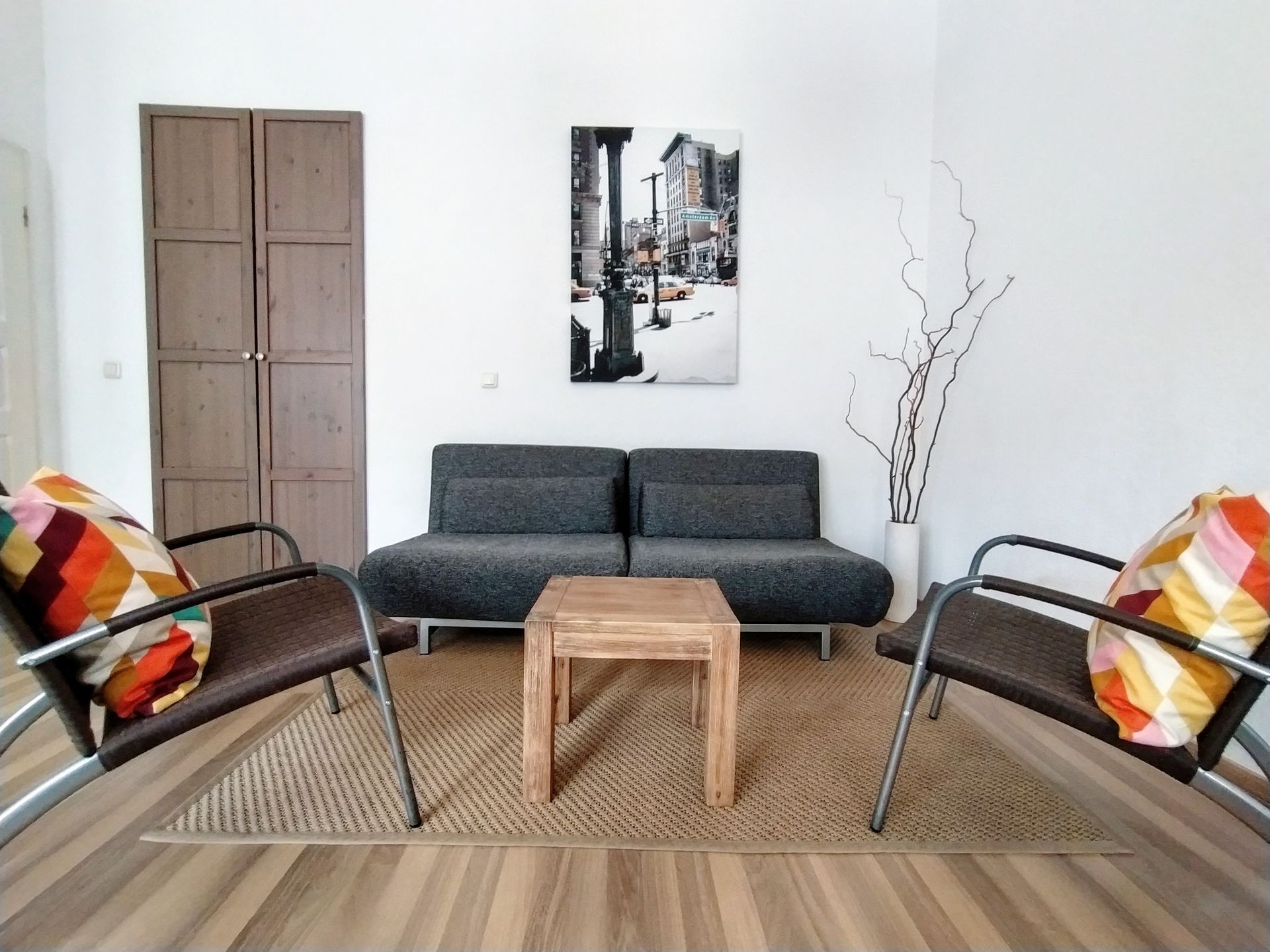 A living room with a couch and two chairs in our Berlin vacation rental