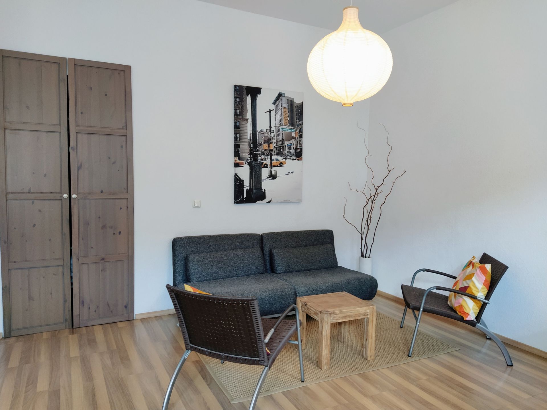 A living room with a couch and two chairs in our Berlin vacation rental