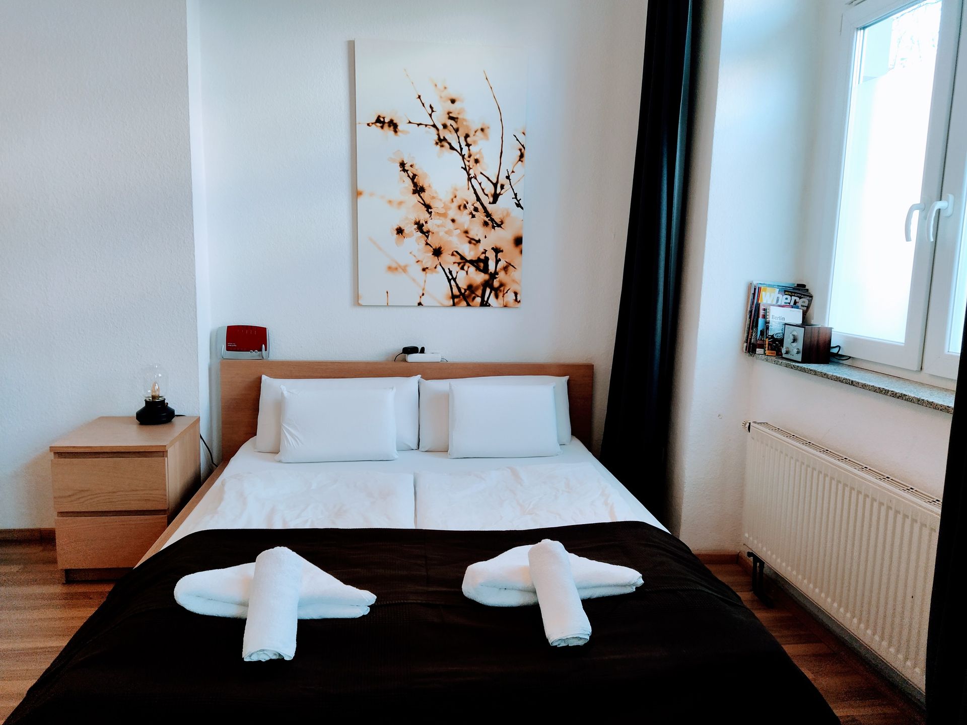 A bedroom with a bed and a painting on the wall in our Berlin vacation rental