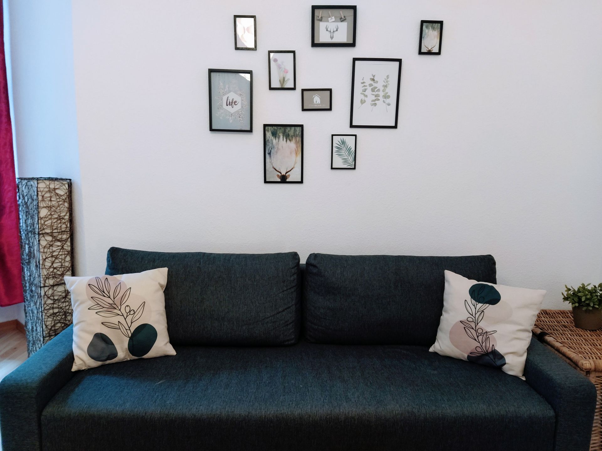 A living room with a couch and pictures on the wall in our holiday rental in Berlin close to the Mauerpark