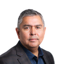 Woman with blonde hair wearing a black blazer smiles at the camera.