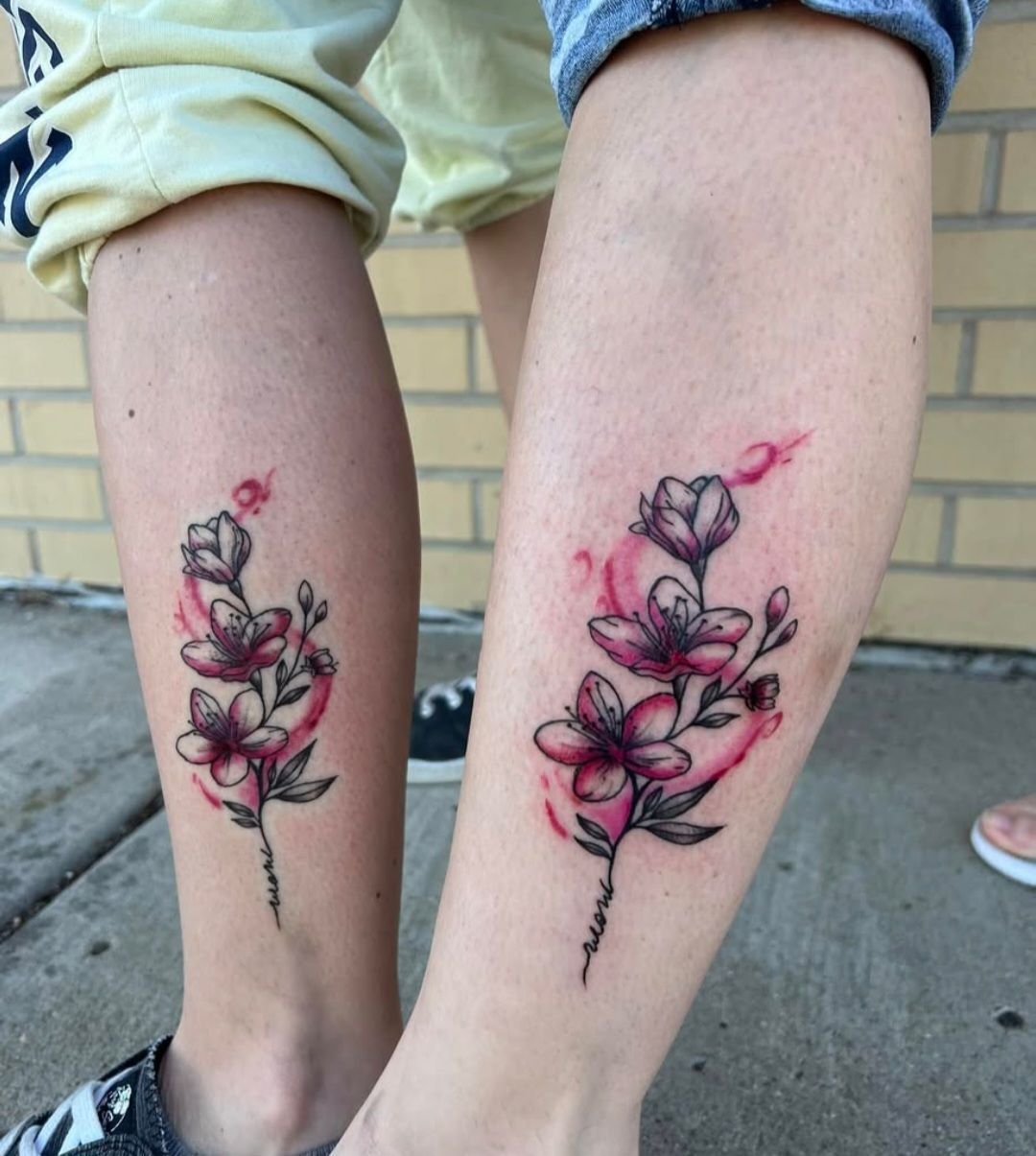 A couple of people with matching tattoos on their legs