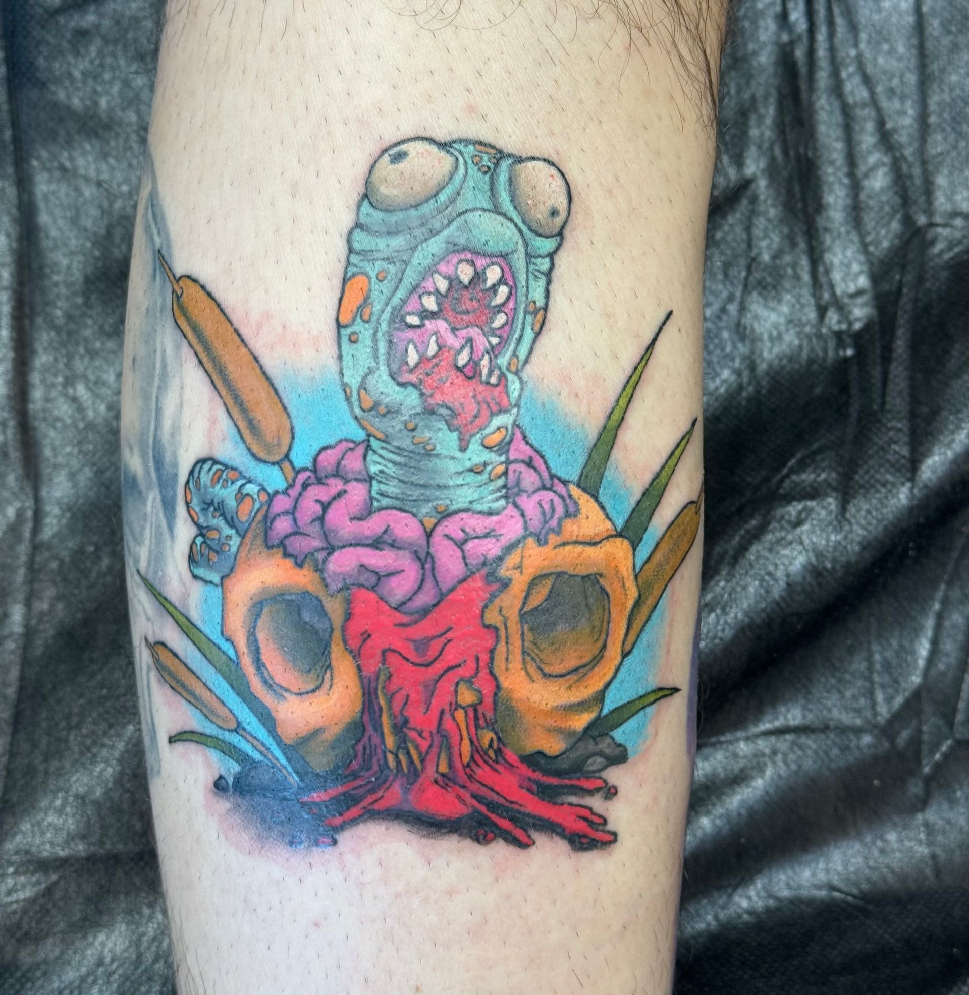 A person is getting a tattoo on their arm.