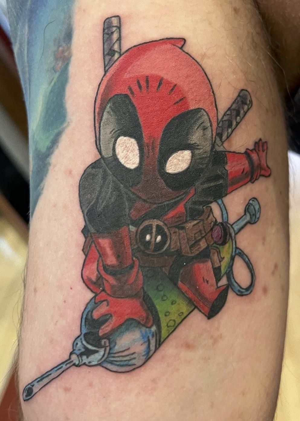 A person is getting a tattoo on their leg